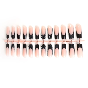 Long coffin press-on nails featuring pink base, black French tips and 3D bow with rhinestones
