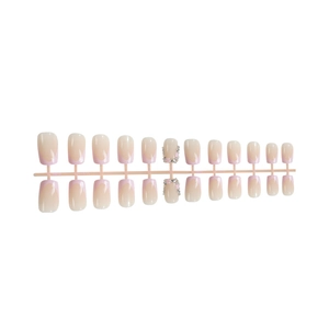 Pink gradient French press-on nails with 3D floral accents and diamond embellishments