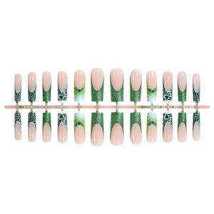 Green glitter French tip press-on nails with 3D rhinestones and long trapezoid shape