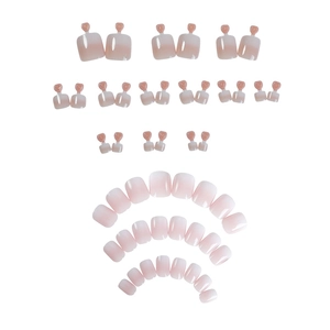 Pink and white gradient press-on toenails set with glossy finish and heart handles
