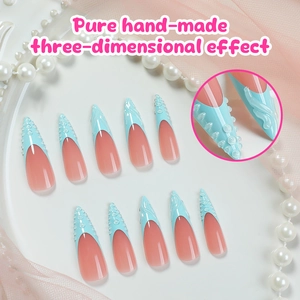 Detail of 3D embossed wave patterns on long stiletto pink and blue French press-on nails