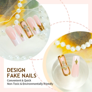 French tip press-on nails with 3D gold cross patterns, rhinestones, and star charms