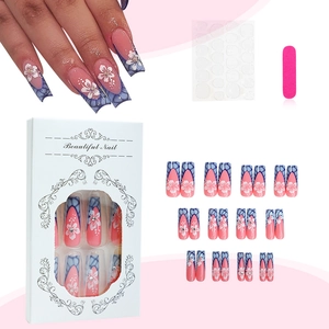 Press-on nail kit with pink gradient, blue lattice patterns and white flower accents