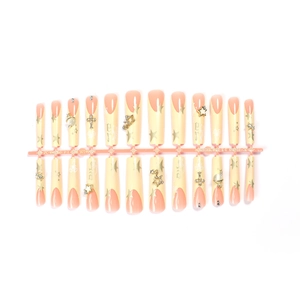 Unghie finte French nude lunghe con stelle dorate, croci 3D e ciondoli in cristallo