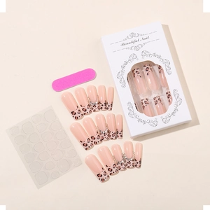 Macro view of 24pcs leopard print french nails set with rhinestones and tool kit
