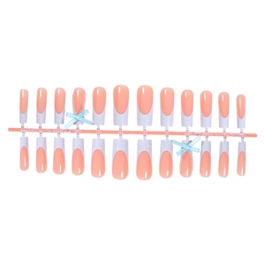 Extra long French tip press-on nails with 3D blue ribbon bows and delicate pearl accents