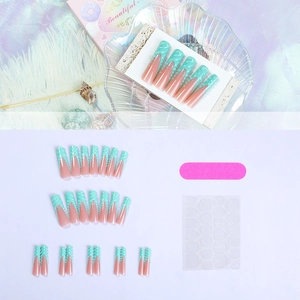 Detail of mint green French tip press-on nails with 3D texture and full application kit