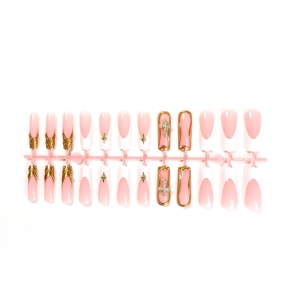 French tip press-on nails with 3D gold patterns, stars and rhinestone cross charms