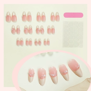 French almond press-on nails with nude gradient, pearls, and application tool kit