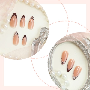 Almond shaped press-on nails with leopard print patterns and brown French tips decor