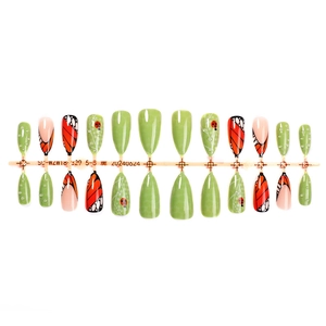 Almond press-on nails with butterfly wings and ladybug designs in green and orange