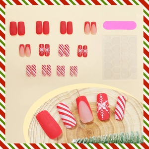 Christmas press-on nails with red white stripes and snowflake designs on square false nails