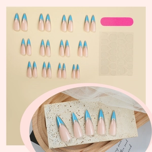 French blue tipped long pointed press-on nails set with nude base and silver line details
