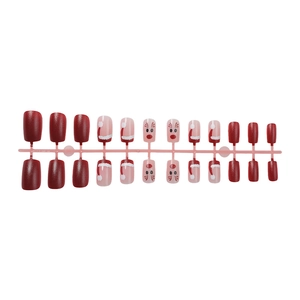 24-piece Christmas press-on nails featuring red matte finish with reindeer and hat designs