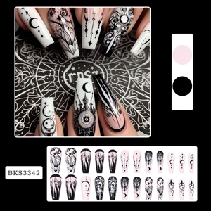 Gothic long trapezoid press-on nails with celestial moon and star patterns in black and pink