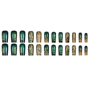 Deep green press-on nails with gold swirl patterns and rhinestones on white background