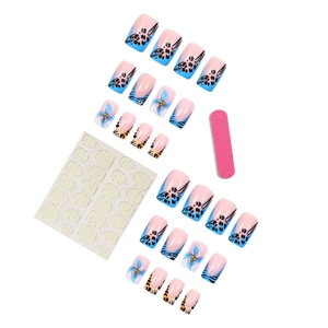 Blue leopard French press-on nails set with floral patterns and gold beads on white background