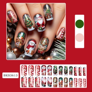 Christmas press-on nails with Santa Claus and tree patterns in festive red and green