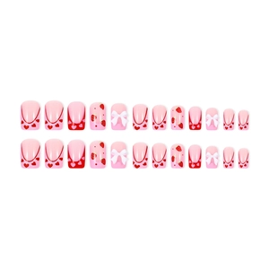 Pink press-on nails with strawberry prints, red hearts and 3D white bow decorations