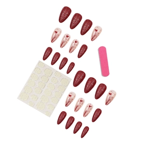 Glittery red almond press-on nails with heart patterns and full accessory kit