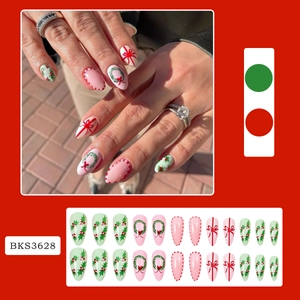 Detailed Christmas press-on nail kit featuring festive wreath and red bow patterns