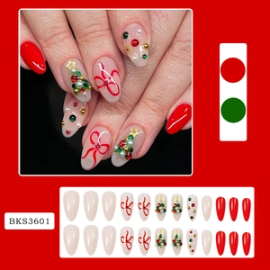 Detail view of 24pcs almond press-on nails with Christmas tree and ribbon designs