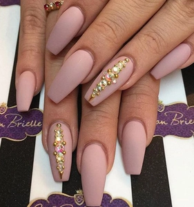 Detail of long coffin press-on nails in matte dusty rose with crystal and gold bead accents