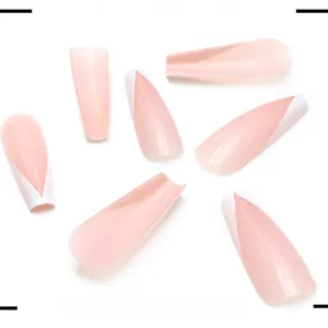 Detailed view of long coffin fake nails with nude pink base and white V-shape French tips