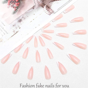 Macro detail of French V-tip press-on nails with gold foil accents on stone background