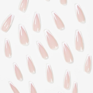 Detail of long coffin press-on nails with sheer pink base and white V-shape French tips