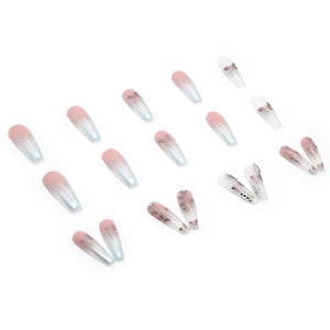 Macro detail of long coffin nails with pink gradient, butterfly patterns and rhinestones