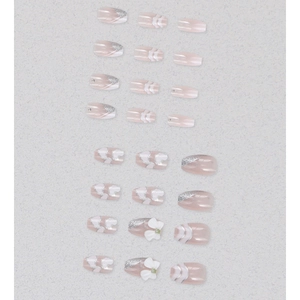 Pink french press-on nails with 3D white bows, heart patterns and silver glitter accents