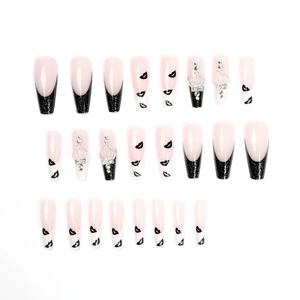 Long ballet press-on nails with black glitter tips, lip prints, and crown rhinestones