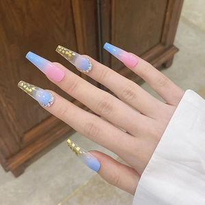 Detailed view of long coffin press-on nails with blue-pink gradient and gold foil accents