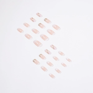 Unghie finte press-on stile francese con sfumatura rosa nude, glitter oro e forma squoval