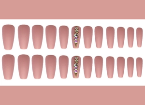 Detail of matte mauve ballerina fake nails featuring rhinestones and golden stud accents