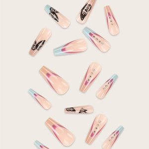 Modern nude press-on nails with blue accents, pink glitter, and black butterfly charms