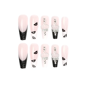Long ballet press-on nails with black French tips, crown charms, and lip prints