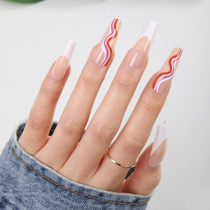 Detailed view of long coffin nails with French tips and red rainbow wave patterns