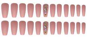 Macro detail of matte dusty pink coffin press-on nails with vertical rhinestones and gold beads