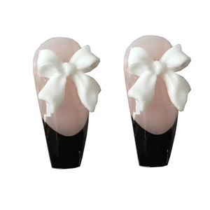 Long trapezoidal press-on nails with black French tips and 3D white bow accents