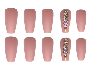 Detail of matte nude pink ballet press-on nails with rhinestones and gold studs decor