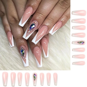 Detail of French V-tip long press-on nails with colorful rhinestones on faux fur