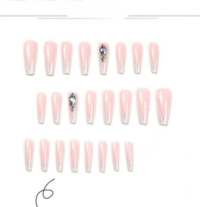 Detail view of 24 pieces long coffin press-on nails with white French tips and rhinestones