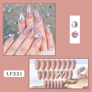 Pink gradient press-on nails set with heart rhinestones and sparkling gem details