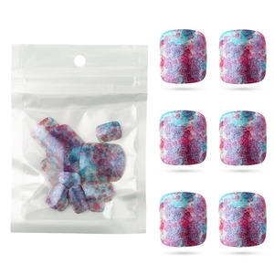 Detail of glittered pink and blue marble press-on toenails in assorted sizes package