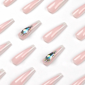 French tip long coffin press-on nails in nude pink with white edges and sparkling rhinestones