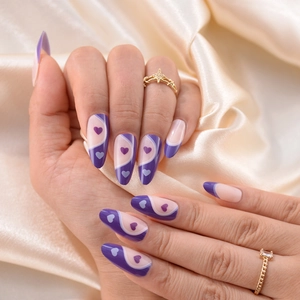 Glossy purple and white almond press-on nails with heart patterns and wavy design