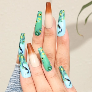 Detail of long coffin press-on nails with blue peacock pattern and brown gradient finish