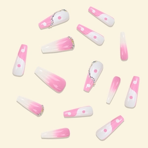 Detailed view of long coffin press-on nails with pink gradient and rhinestone accents